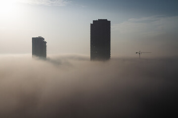 Heavy fog in Tel Aviv city. View above. Buildings stick out of the fog