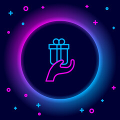 Glowing neon line Give gift icon isolated on black background. Gift in hand. The concept of giving and receiving a gift. Colorful outline concept. Vector