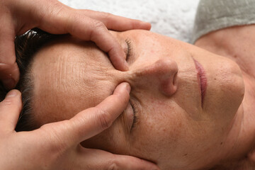 Ostheopath massaging a female patient