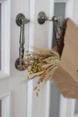 A bouquet of dried flowers in a craft package