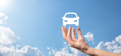 Male hand holding car auto icon on blue background. Wide banner composition.Car automobile...