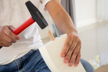 Man assembling furniture at home