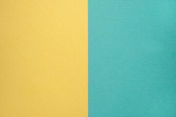 Two colored papers with a blue and yellow overlay on the floor. they divide half of the image. Dual...