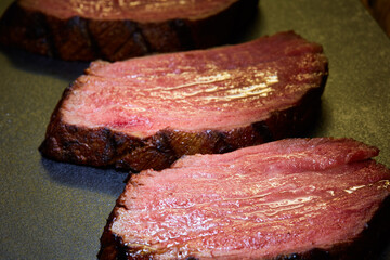 Sous-vide steak cut into pieces, cooked to eat beef on the stone table