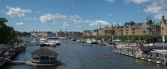Bridge view over the bay Ladugårdsviken with boats and amusement buildings in Stockholm