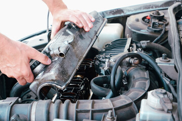 Car repair. Auto mechanic working on car engine in mechanics garage. Repair service. close-up shot
