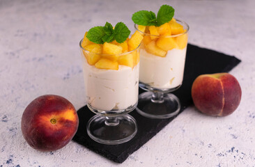 Light dessert with peach and cream cheese on a white plate.