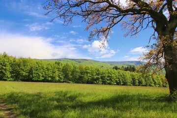 Beautiful scenery of the mountains and view to the transmitter with green forests and blue sky above at White Carpathians, Czech republic