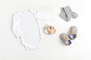 Mockup of white infant bodysuit made of organic cotton with eco friendly baby accessories. Onesie...