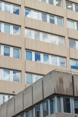 facade with glass windows in which the clouds are reflected
