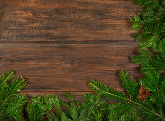 Close up fresh Christmas tree branches over wood