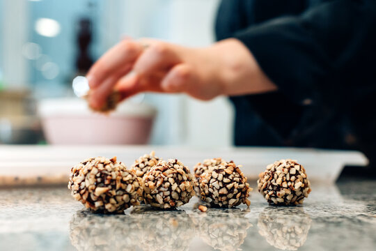 Pastry chef working inside chocolatier bakery workshop - Focus on pralines