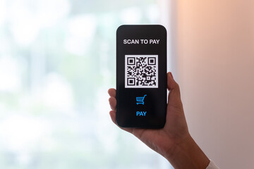 People's hands are using smartphones to scan QR codes.