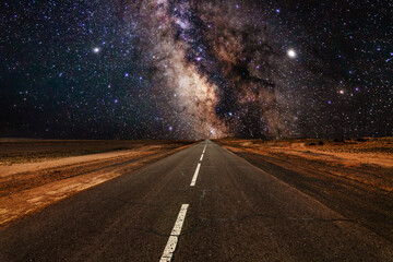 Milky Way over an empty road. Road to infinity.