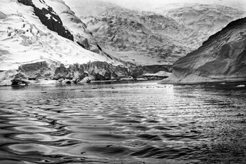 Black and white glacier Paradise Bay Skontorp Cove Antarctica. glacier is blue because air is squeezed out of snow.