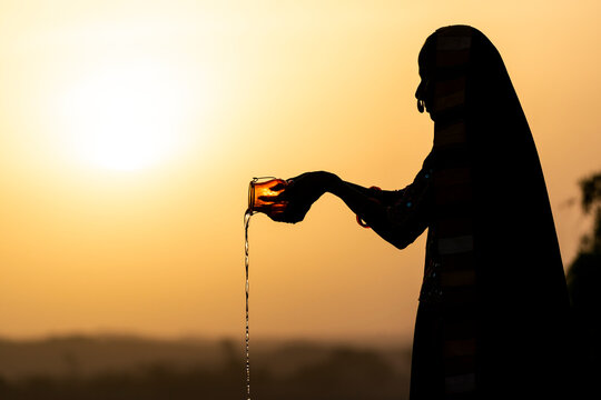 India Gujarat Bhuj Great Rann of Kutch Ahir Tribe. An Ahir woman makes an offering to the deities.