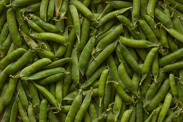 Green peas in the market. Fresh beans background.