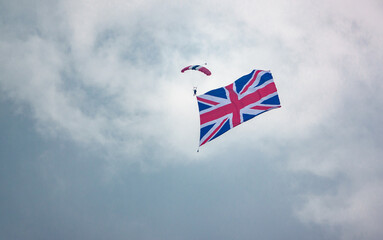 parachutist display team member descends with a huge union flag in tow