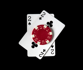 Poker game with one pair combination. Chips and cards on the black table in poker club.