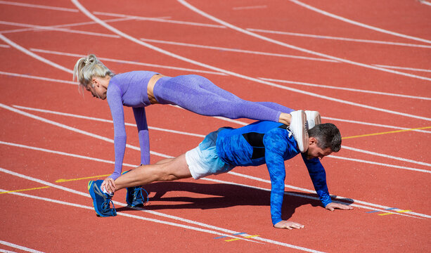 sport couple team in sportswear training on stadium, core