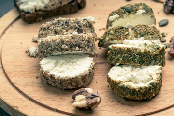 sliced white soft cheese on a wooden board for cutting
