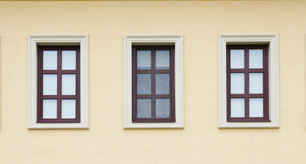 Fototapeta na wymiar Three windows on wall of house.