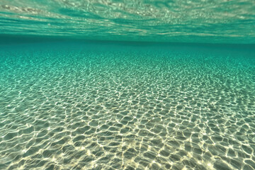 Split underwater photo of exotic island paradise bay with crystal clear emerald sandy beach