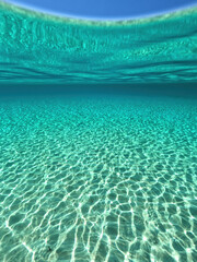 Split underwater photo of exotic island paradise bay with crystal clear emerald sandy beach