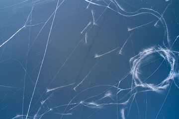 Top view of the blue ice with numerous traces of skates. Shooting from a drone. Copy space.