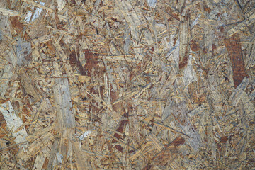 Surface view of OSB board made from wood chips. Wood texture, background, pattern.