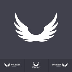 Obraz premium Pair Wings of Bird Icon in Flat Style. Winged Logo Company Icon Flying, Eagle, Falcon, Phoenix, or Hawk Wings. Brand or Logotype on Dark Background