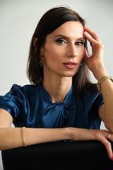 portrait of a beautiful young woman in a blue shirt