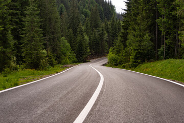 Fototapeta na wymiar wavy road in the mountains and forest