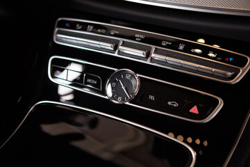 Luxury car interior details. Middle console with air and multimedia controls