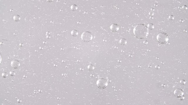Macro Shot of air Bubbles in Transparent Cosmetic Liquid Gel Cream. Fluid texture With Bubbles. Slow motion . High quality 4k footage