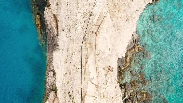 Top down drone raising shot of broken bridge at Porto Katsiki coast at Lefkada island, Greek famous beaches.