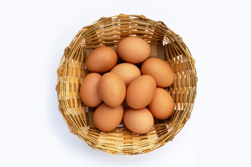 Fresh eggs in bamboo basket on white background. Copy space