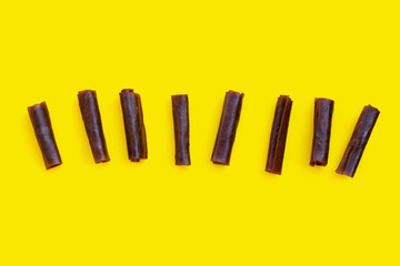 Dried mango paste on yellow background.