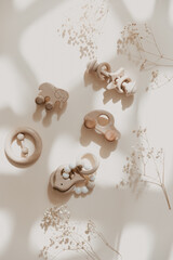 Baby wooden toy eco natural. Scandinavian nordic style on beige background. Mockup. Top view. Copy space.