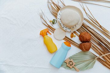 Bottle of sunscreen lotion with kids toys and beach accessories. Skin care and protection concept for children. Flat lay, top view