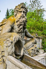 Fototapeta na wymiar Kuks, Czech republic - May 15, 2021. Steps with water cascade and statue of Triton - greek god of the sea - on both side of stairs