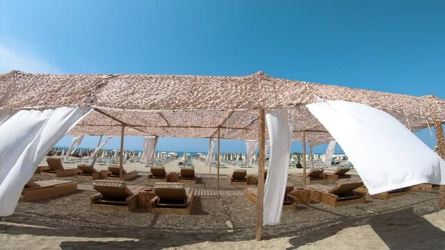 Suumer vacation luxury resort white tent on a sandy beach against the background of blue sunny sky