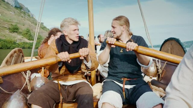 Viking Men Row Vigorously on Drakkar. The Vikings Sail on an Old Ship