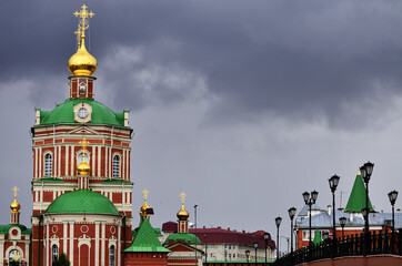 View of the golden domes of the Resurrection Cathedral under a gloomy sky. Russia Yoshkar-Ola 01.05.2021. High quality photo