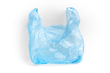 Blue plastic bag with handles on a white background. The used plastic bag may be recyclable. Recycling of plastic waste into pellets as a business.
