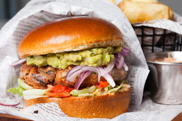 Classical hamburger with baked meat served on wooden board