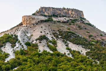 Fototapeta na wymiar Tepe-Kermen is an ancient cave town in Crimea. Scenic sunny day landscape.