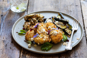 Vegan mix of miso aubergine, roasted cauliflower and baby courgettes