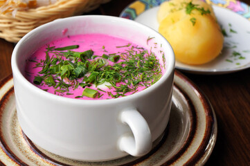  Cold beetroot soup with greens and hot potatoes. Selective focus.