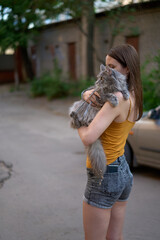 Girl walks with a cat.